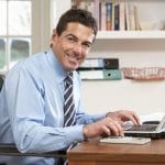 man working from home using laptop